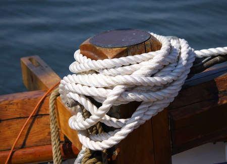 White boaters rope tied to dock boatの写真素材