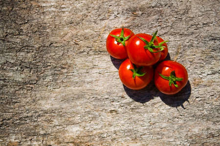 red tomatoes on a wooden tableの写真素材