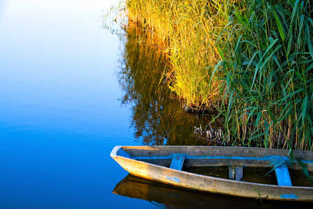 lone boat on calm waterの写真素材