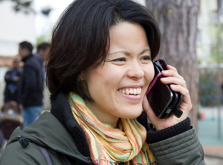 woman happy and dynamic calling with his mobile phoneの写真素材