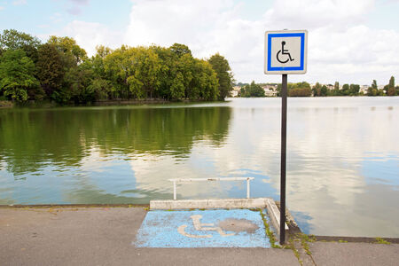 Place for wheelchair, in front of a pond.の写真素材