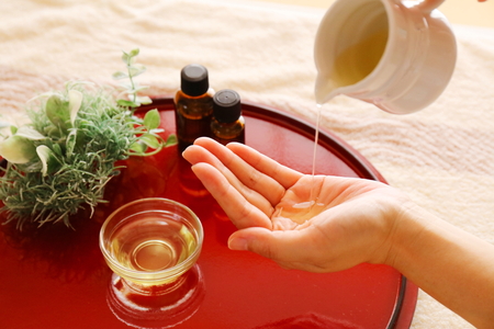 Red tray with aroma oil imagesの写真素材