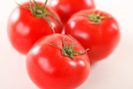 Tomatoes isolated on whiteの写真素材