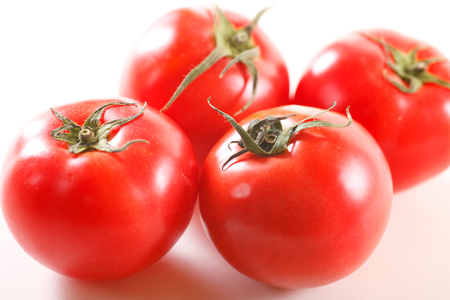 Tomatoes isolated on whiteの写真素材
