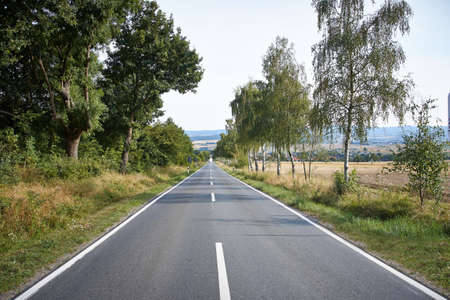 Road Running Through Fields summer cloudscape の写真素材
