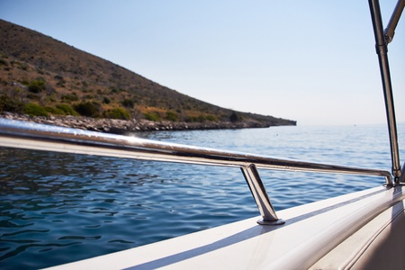yacht approaching deserted Rocky Island in Croatia  の写真素材