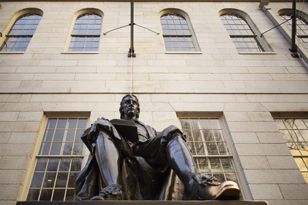 John Harvard statue. Tourists, and aspiring students from all over the world, rub his shoe for good luck.のeditorial素材