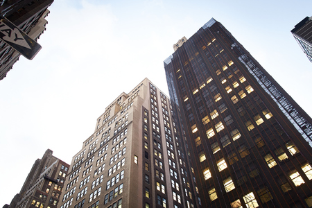 This view of the skyscrapers in New York gives an opportunity to insert text or graphics  Tall corporate building against a white sky の写真素材