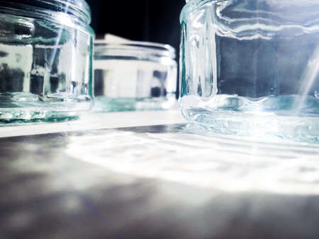 Glass on table with flares of sunの素材