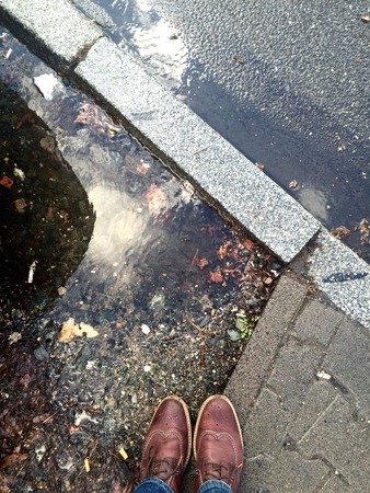standing next to the street in Frankfurt, Germany. Big puddles after heavy rain. Thunderstorm...