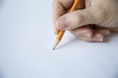 Hand Writing on Blank Paper With a Pencilの写真素材