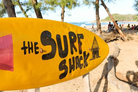 yellow surfboard sign leading to the surf shack in Tofo, Mozambique