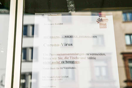 Coronavirus lockdown. Frankfurt, Germany. April 5, 2020. Coronavirus warning sign printout in German on glass.のeditorial素材