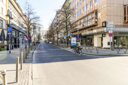Coronavirus lockdown. Frankfurt, Germany. April 5, 2020. Street in downtown Frankfurt with no traffic and one bicycle rider during quarantine.のeditorial素材