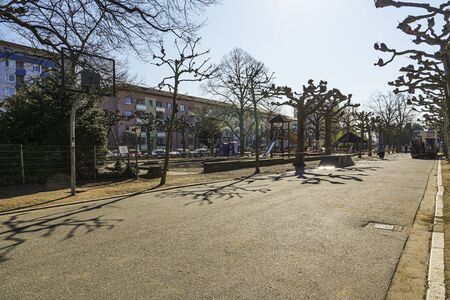 Neighborhood park with children's play area in Frankfurt with few people. Coronavirus quarantine. Long shot.の写真素材