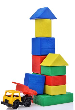 plastic toy truck with wooden cubes tower. Building process. isolated on white backgroundの写真素材