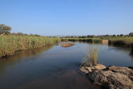 Sabie river in Kruger National Park with 1912 train bridgeの写真素材