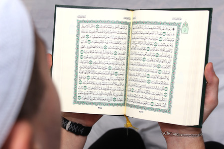 Young man reading the Holy Koran