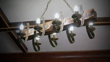 Interior design and ceiling decoration of a building, cafe, restaurant. The ceiling is decorated with an environmentally friendly chandelier and wooden structure. nの写真素材