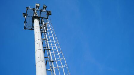 High lighting mast against the blue sky. View from below. Full height. nの写真素材