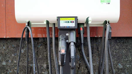 Charging battery of an electric car. Power supply unit for charging electric vehicles. Electric vehicle charging station. Clean energy of the future.のeditorial素材