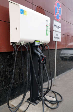 Charging battery of an electric car. Power supply unit for charging electric vehicles. Electric vehicle charging station. Clean energy of the future.のeditorial素材