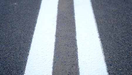 Asphalt road with marking lines white stripes. Two solid lines. n