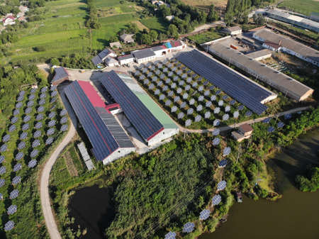 Solar panels lines in the field with big storm cloud in the sky. nの写真素材