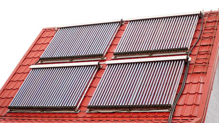 Solar glass tube hot water panel array mounted on a tiled roof. Solar Power House 3d concept, Solar Panels With Lens Flare, Solar Water heating systems, Renewable Energy Home, Water Heaters Panels On a Roof - 3D Renderingの写真素材