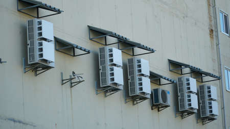 Air compressor or air condenser unit located on deck building to heat released transferred to surrounding environment, Compressor is part of cooling function and air roof conditioning HVAC systems. outdoor ventilation.の写真素材