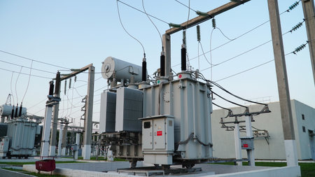 power transformer. electrical equipment. electric substance. High voltage transformer against the blue sky. Electric current redistribution substation.の写真素材