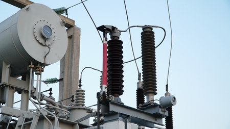 power transformer. electrical equipment. electric substance. High voltage transformer against the blue sky. Electric current redistribution substation.の写真素材