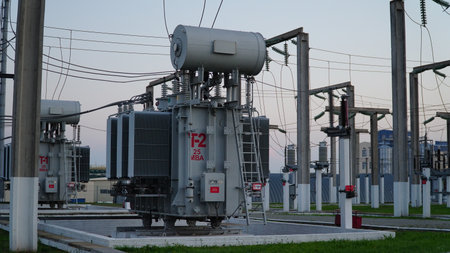 power transformer. electrical equipment. electric substance. High voltage transformer against the blue sky. Electric current redistribution substation.の写真素材