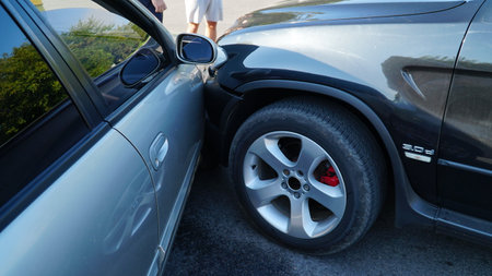 traffic accident. wrecked car. Car crashed into parked car on neighborhood streetの写真素材