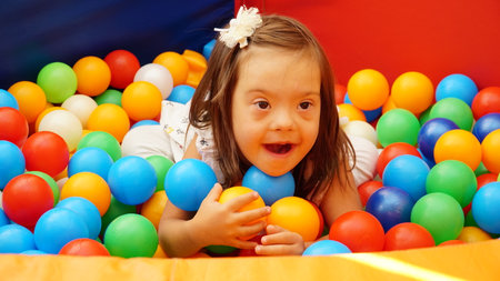Ukraine Vinnitsa 09 27 2023 Girl with Down syndrome playing with geometrical shapes. nのeditorial素材