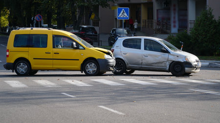 Traffic accident. Wrecked car. Car crash accident on street, damaged automobiles after collision in city. nの写真素材