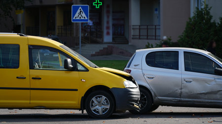 Traffic accident. Wrecked car. Car crash accident on street, damaged automobiles after collision in city. nの写真素材