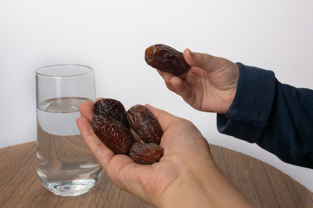 yand hold dates, iftar time. ramazan, a glass of waterの写真素材