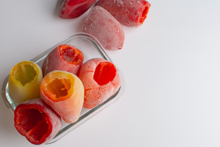 freezing vegetables. glass dish with bell peppers in the snow. view from aboveの写真素材