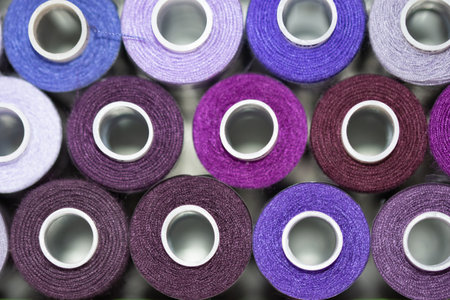 spools of thread for sewing lilac and purple hue top viewの写真素材