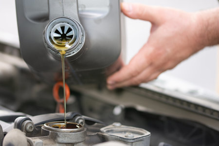 jet of automobile oil is poured into the engineの写真素材