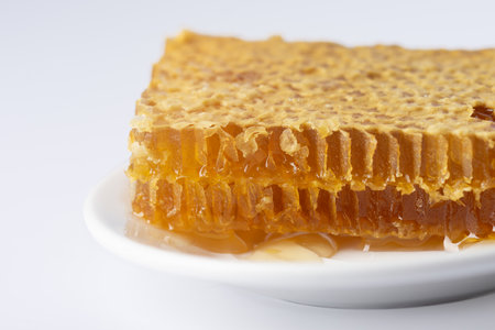 honey in honeycomb on white background, healthy eating.