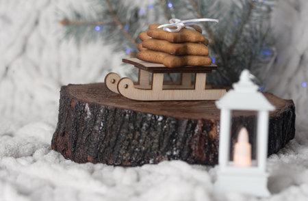 Christmas composition, wooden stand and small decorative sled with gingerbread.の写真素材