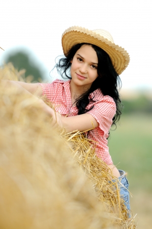 Beautiful girl enjoying the nature in the hayの写真素材