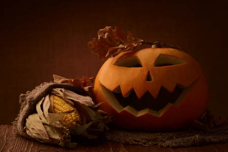 Scary halloween pumpkin jack-o-lantern on dark backgroundの写真素材