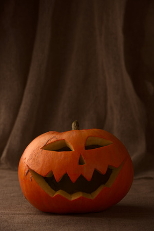 Scary halloween pumpkin jack-o-lantern on dark backgroundの写真素材