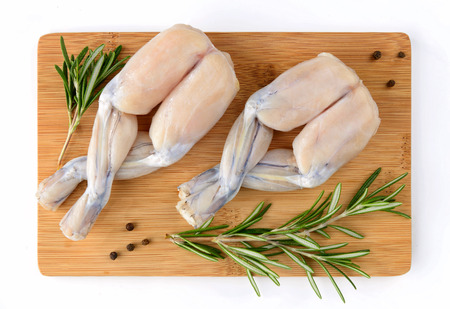 Two Pairs of Fresh Frog Legs isolated on white backgroundの写真素材
