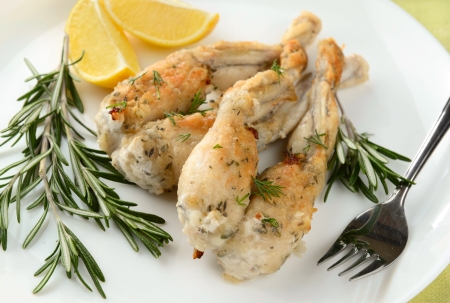 Frogs Legs Fried with Garlic and Herbs and Lemonの写真素材