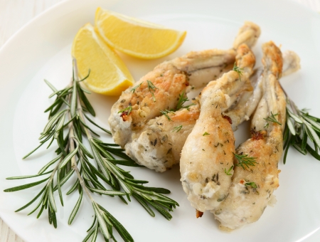 Frogs Legs Fried with Garlic and Herbs and Lemonの写真素材