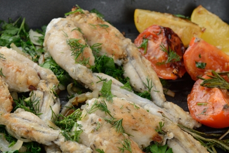 Frogs Legs Fried with Garlic and Herbs and Lemonの写真素材